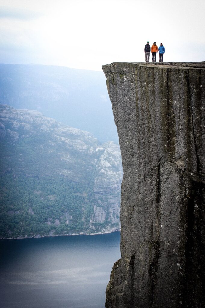 Three Men on Cliffside - Slate Recovery